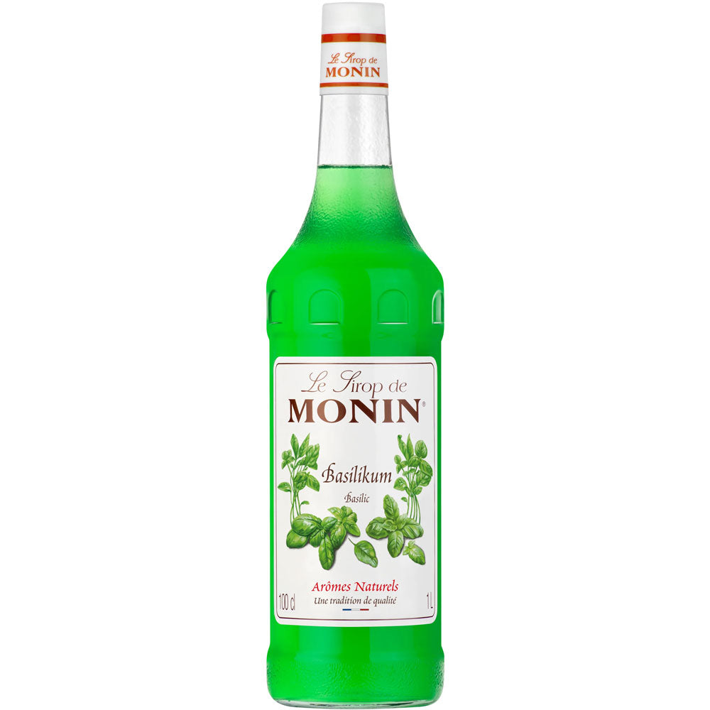 Eine 1-Liter-Flasche Monin Basilikum Sirup mit weißem Etikett und Basilikumblattmotiven - ideal, um Getränken und Desserts eine frische, vegane Note zu verleihen.