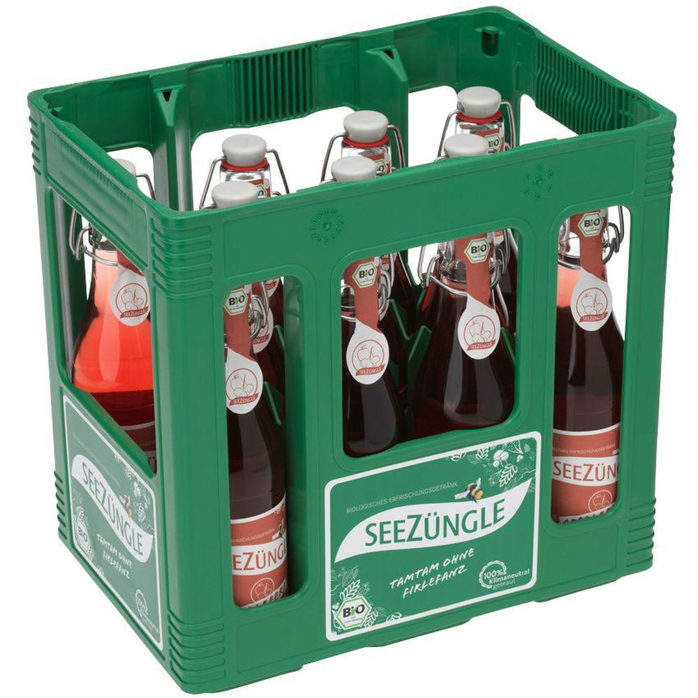 Eine grüne Kiste mit elf Glasflaschen Seezüngle Apfelbeere BIO (0,33 l, Mehrweg), die jeweils mit rotem Bio-Saft gefüllt und mit der Marke Seezüngle beschriftet sind.