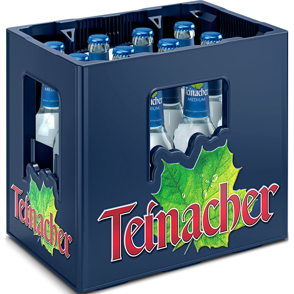 Eine Kiste Teinacher Mineralwasser Medium 12x0,33L (Mehrweg) in einer blauen Schachtel mit grüner Blattgrafik und einem auffälligen roten Logo mit mittlerem Kohlensäuregehalt.