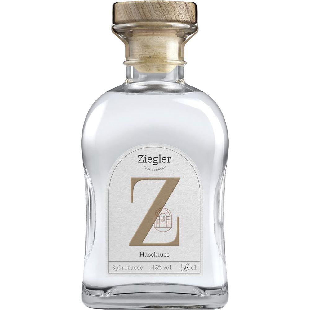 Ziegler Haselnuss Spirituose 43% 0,5 Liter-diese Premium-Spirituose von Ziegler bietet echten Haselnussgeschmack in jedem Schluck, präsentiert in einer klaren Flasche mit Holzverschluss und weißem Etikett.