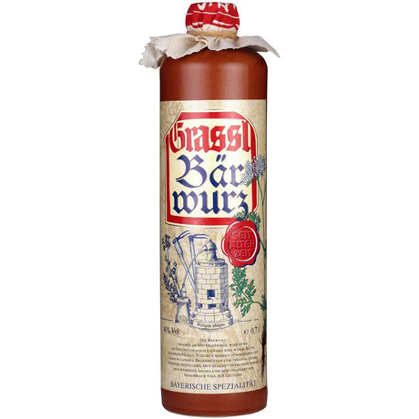 Eine 0,7-Liter-Flasche Grassl Bärwurz 40% von Grassl, ein klassischer bayerischer Kräuterlikör mit dekorativem Etikett und stoffumwickeltem Verschluss.