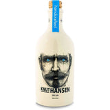 Weiße Ginflasche mit Korken, auf der das Gesicht eines bärtigen Mannes mit blauen Augen abgebildet ist, mit der Aufschrift Knut Hansen Dry Gin 42% 0,5L - ein Premium Craft Gin von Knut Hansen aus Hamburg.