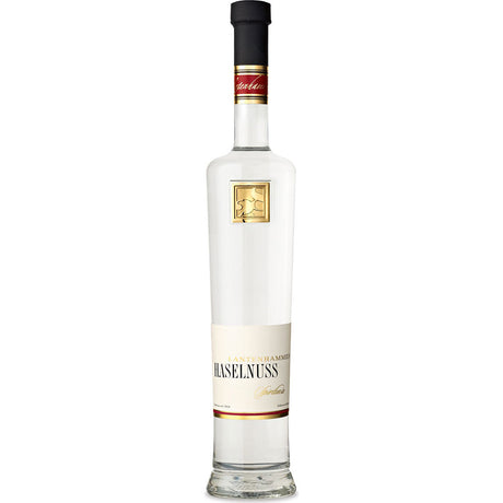 Lantenhammer Haselnussspirituose 42% 0,5 Liter kommt in einer hohen Klarglasflasche mit einem weiß-goldenen Etikett, das die traditionelle Nussbrand-Handwerkskunst der Marke unterstreicht.