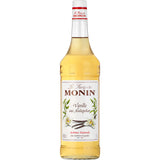 Monin Vanille Sirup 1 Liter: Eine 1-Liter-Flasche von Monin mit einem weißen Etikett, das mit Vanilleblüten und -schoten verziert ist, hergestellt aus feiner Madagaskar-Vanille.