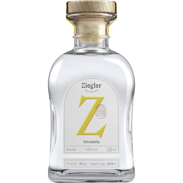 Eine Klarglasflasche Ziegler Mirabellenbrand 43% 0,5 Liter mit einem Holzdeckel und einem weißen Etikett mit einem markanten gelben Z.